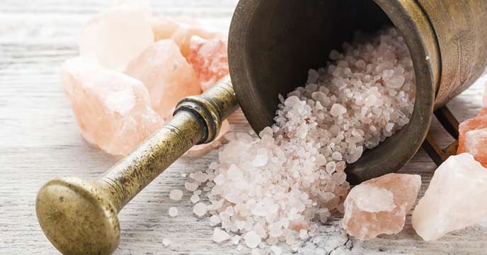 Himalayan rock salt crystals on a wooden spoon
