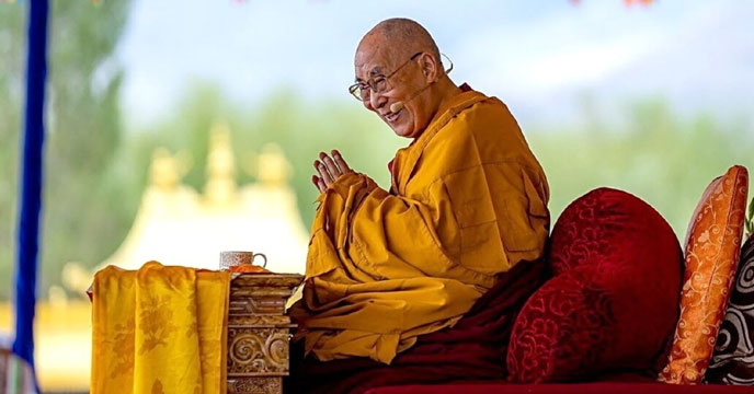 Dalai Lama kissing a child on a public platform
