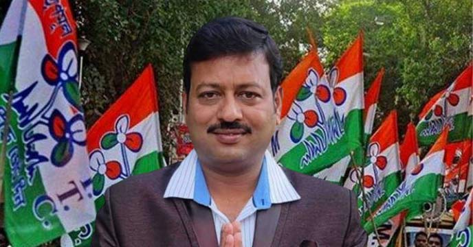 Jiban Krishna Saha, a key figure in the TMC recruitment scam, standing in front of microphones and cameras during a press conference.