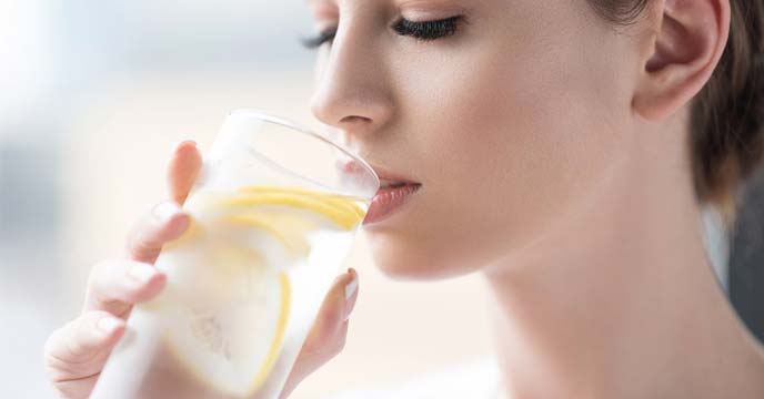 A girl drinking lemon water in summer