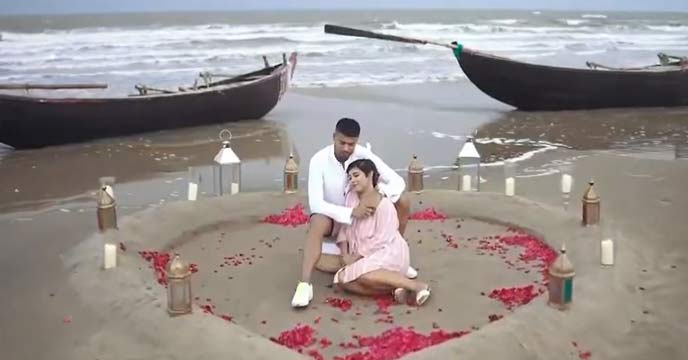 Pritam Kotal and his newlywed wife posing for a photo