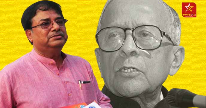 Udayan Guha pictured with a portrait of Jyoti Basu in the background