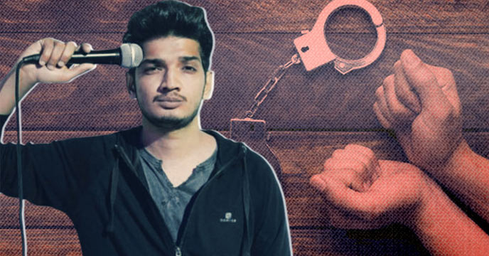 Comedian Munawar Faruqui standing in front of a microphone on stage