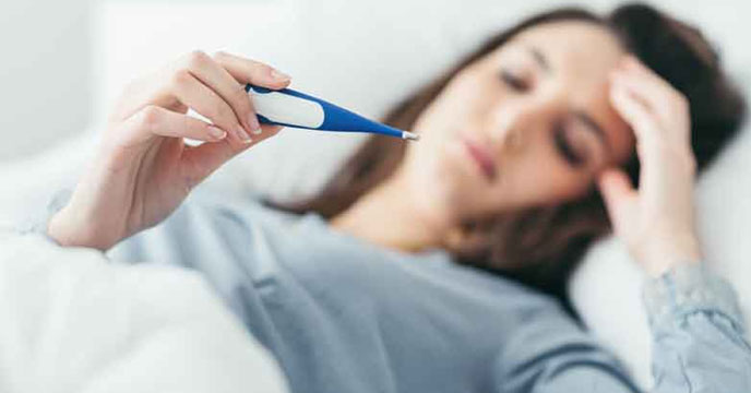 Woman measuring her temperature