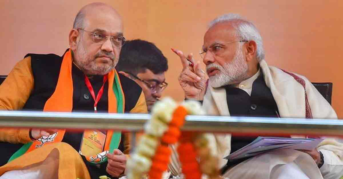 Two BJP Leader, Narendra Modi and Amit Shah, standing together in a political setting, discussing or addressing a crowd