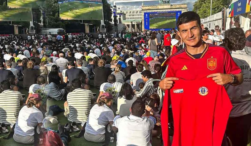 Saul Crespo Embraces Euro Spirit in Berlin with Red-and-Yellow T-Shirt in Hand"