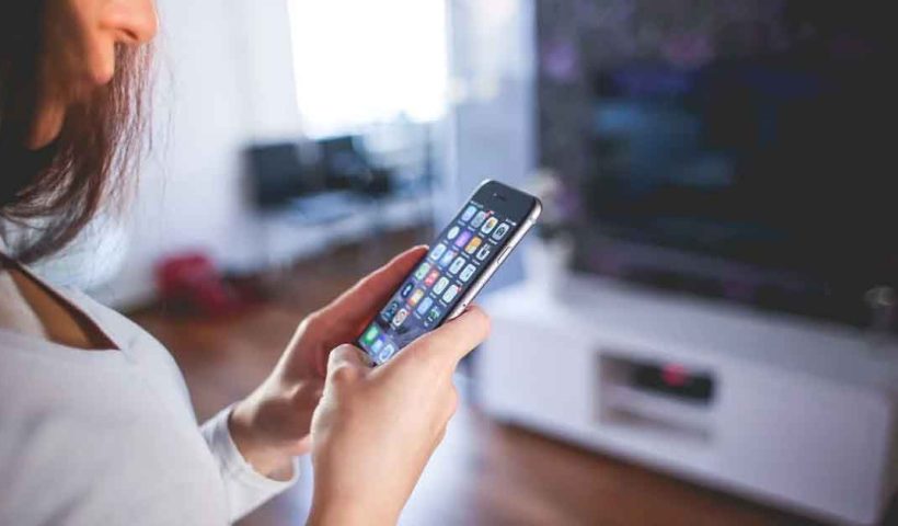 Woman Wearing White V Neck Shirt Using Spac Iphone