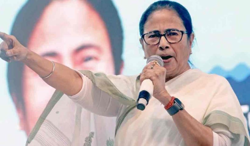 Portrait of Mamata Banerjee, the Chief Minister of West Bengal, wearing a traditional white saree and offering a namaste gesture.