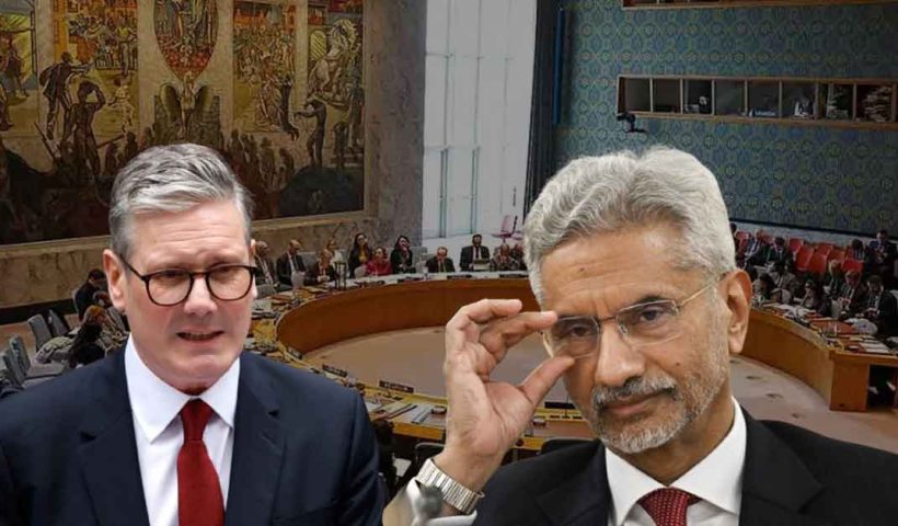Indian External Affairs Minister S. Jaishankar standing with UK Prime Minister Rishi Sunak, both in formal attire, engaging in conversation against an official setting. Jaishankar is gesturing with his hand, while Sunak listens attentively, highlighting the diplomatic interaction between the two leaders