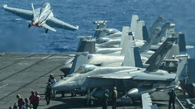 An F/A-18 fighter jet takes off from a US aircraft carrier